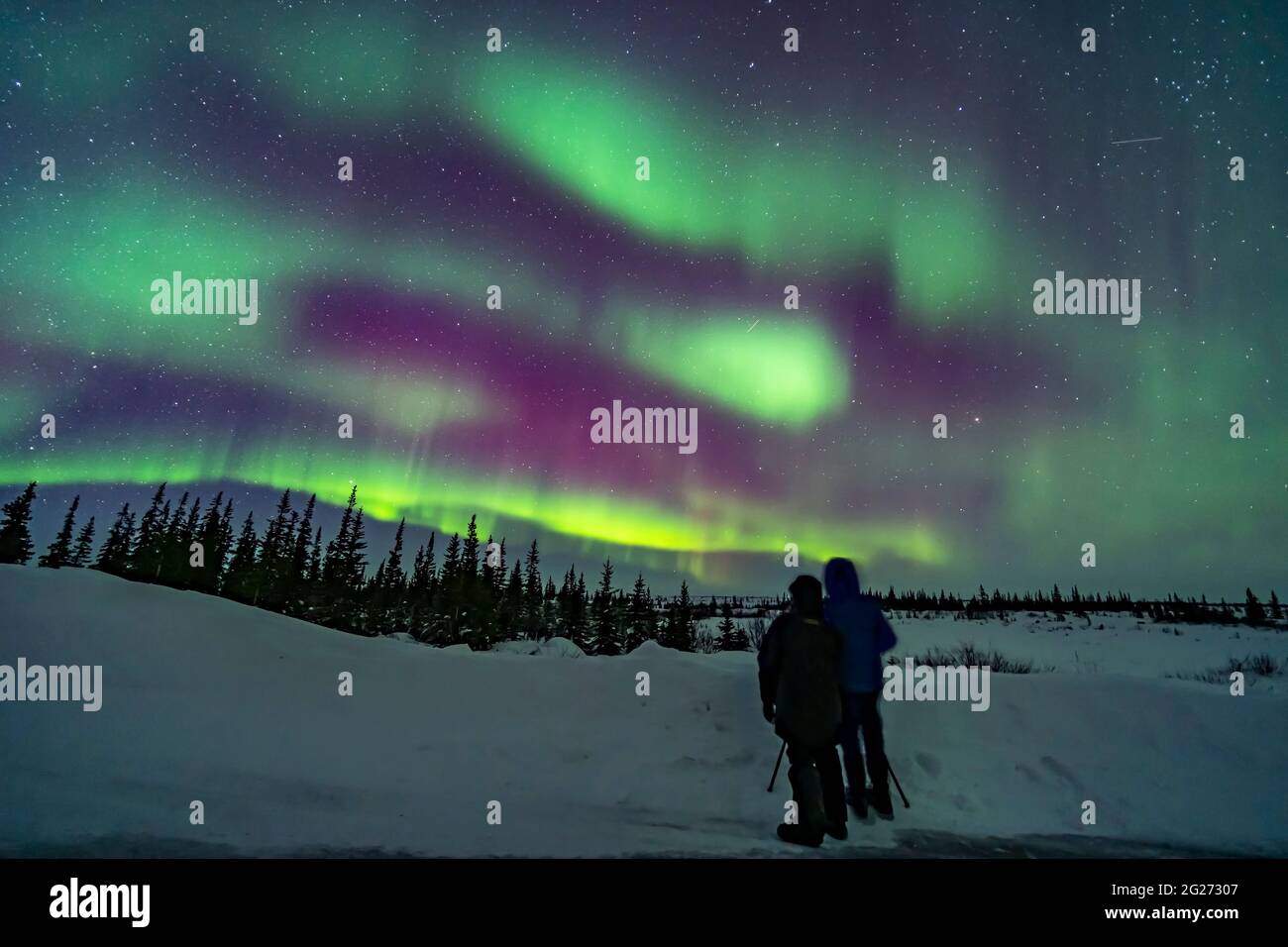 A couple watching the northern lights in Canada. Stock Photo