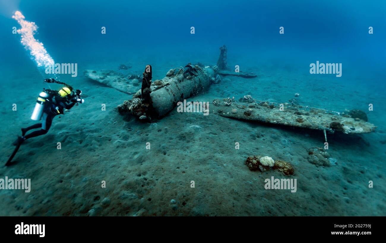 Diver exploring the Mitsubishi Zero Wreck, Kimbe Bay, Papua New Guinea. Stock Photo
