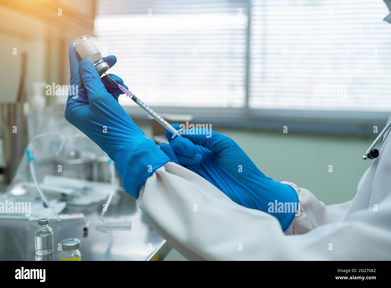 Close up doctor hands holding syringe for drawing vaccine drug Stock Photo