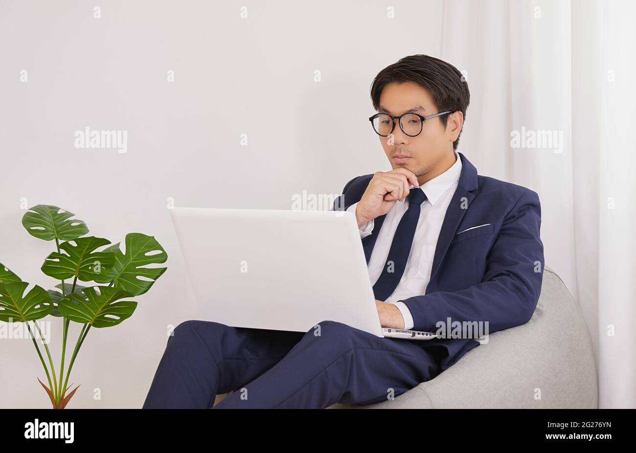Asian Financial Advisor Wear Glasses Using Laptop and Thinking Work in ...