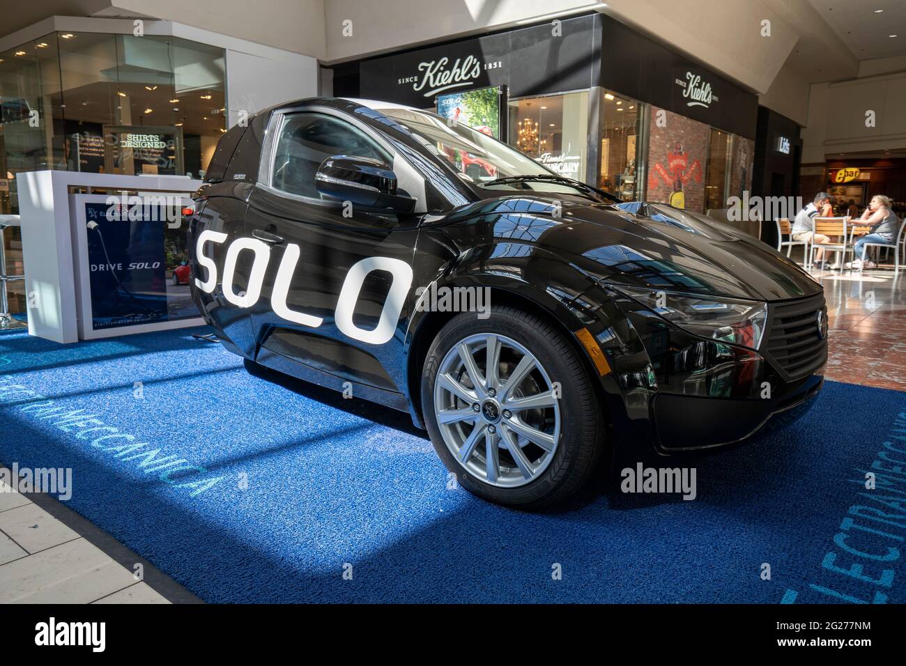 ElectraMeccanica Solo EV, a tiny three-wheeled electric car, is seen charging while on display in Washington Square Shopping Mall in Tigard, Oregon ... Stock Photo