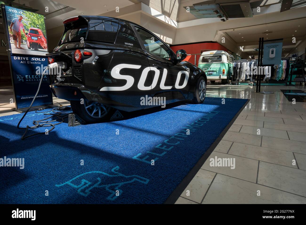 ElectraMeccanica Solo EV, a tiny three-wheeled electric car, is seen charging while on display in Washington Square Shopping Mall in Tigard, Oregon ... Stock Photo