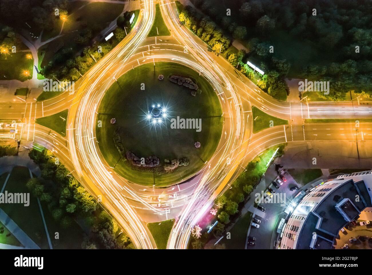 aerial top view of urban roundabout with car light trails at night. motion blur. Stock Photo