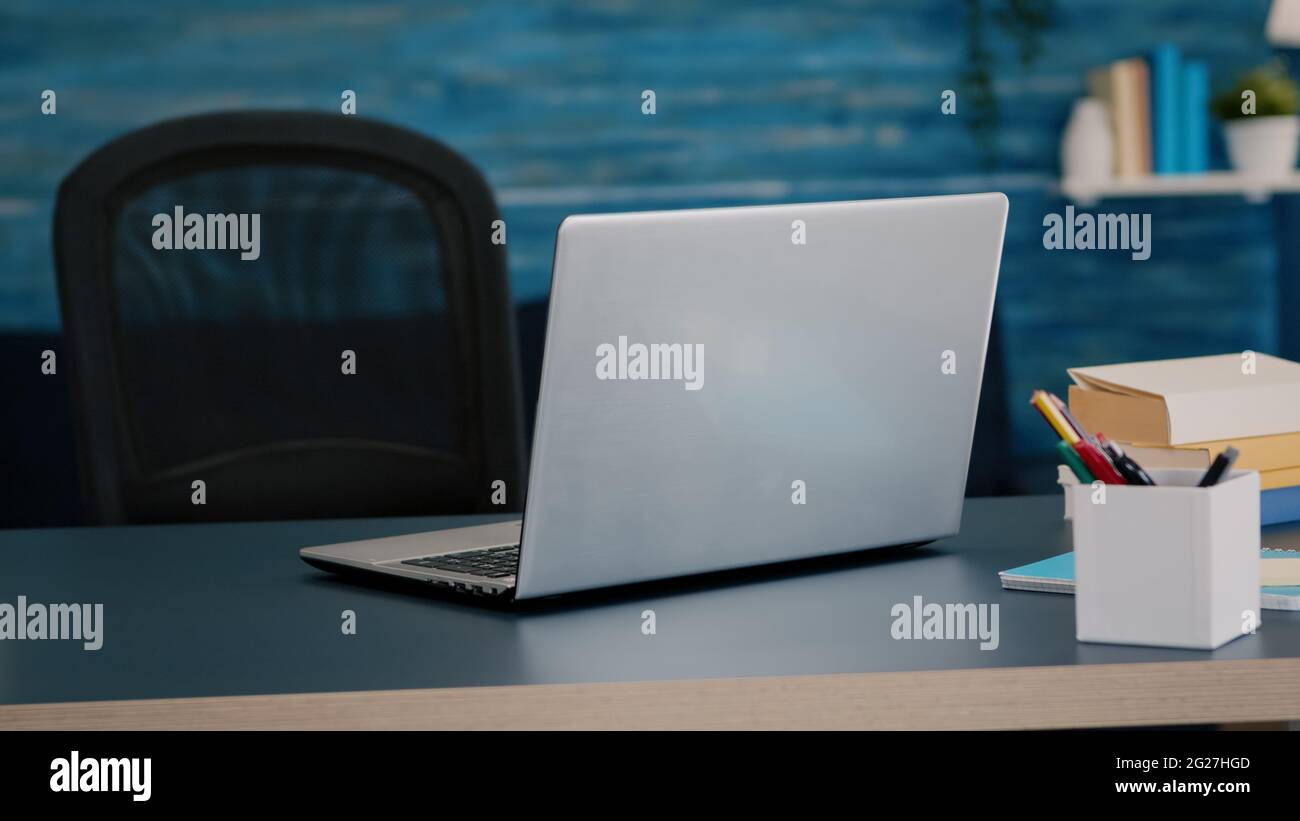 Close up of laptop computer placed on modern working desk in empty home ...