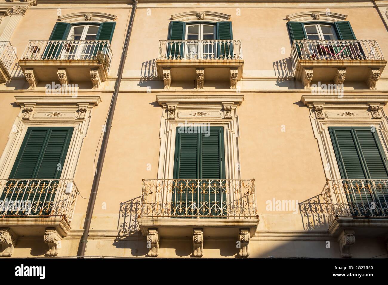 Building exterior with windows and balconies in Sicily, Italy Stock Photo -  Alamy