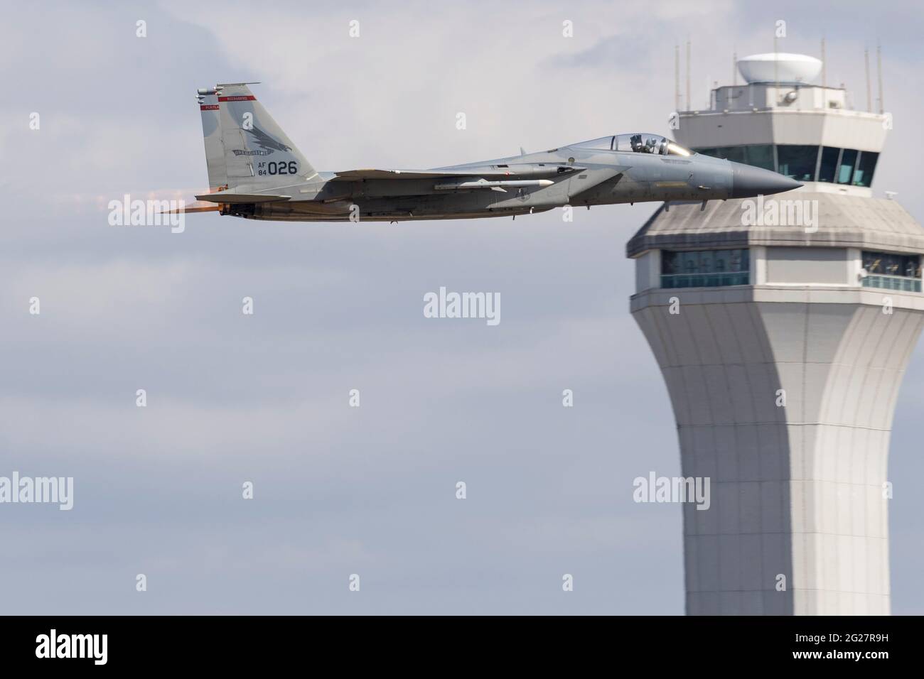 An Oregon Air National Guard F-15C Eagle takes off past the air traffic control tower. Stock Photo