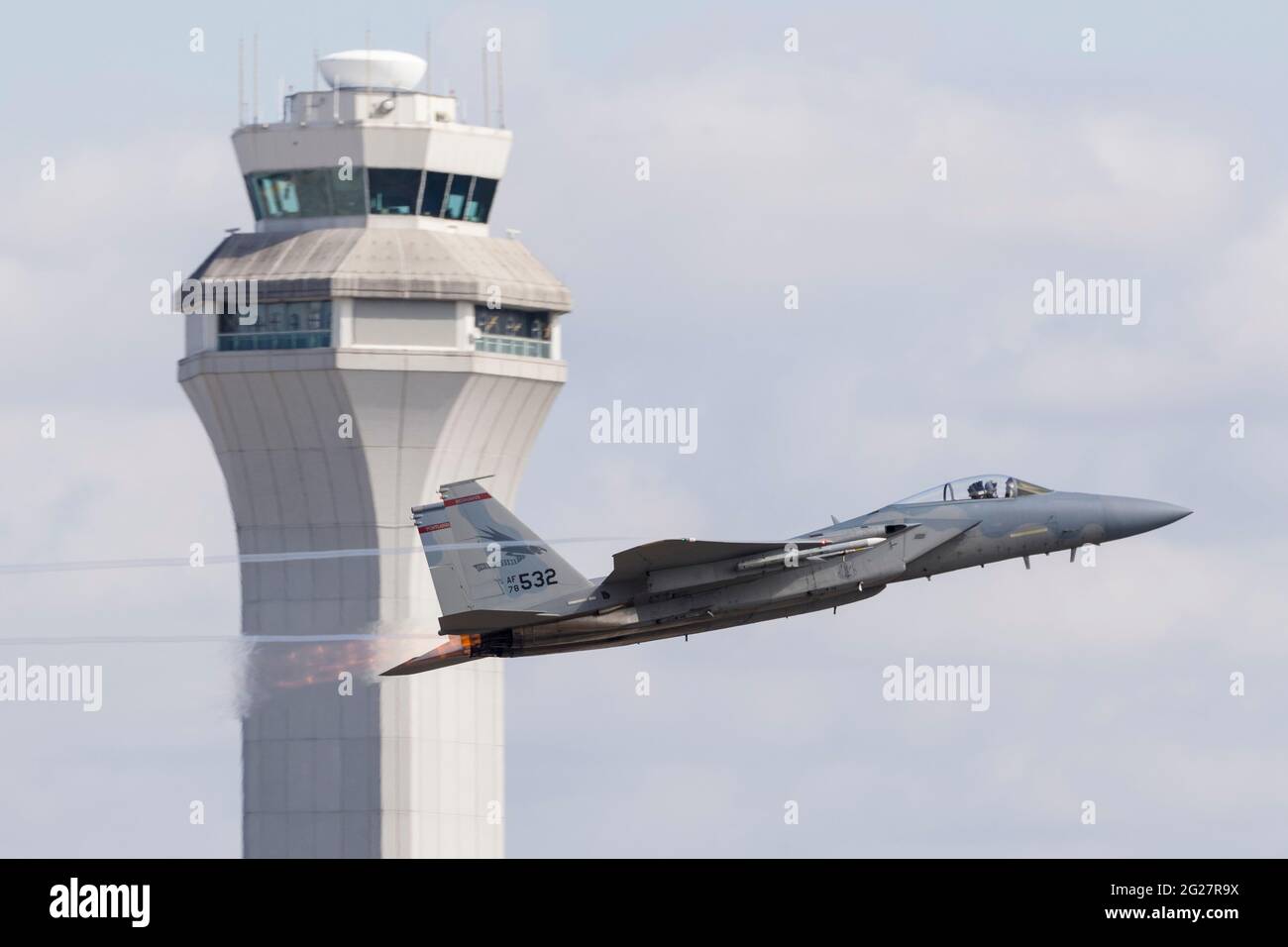 An Oregon Air National Guard F-15C Eagle takes off past the air traffic control tower. Stock Photo