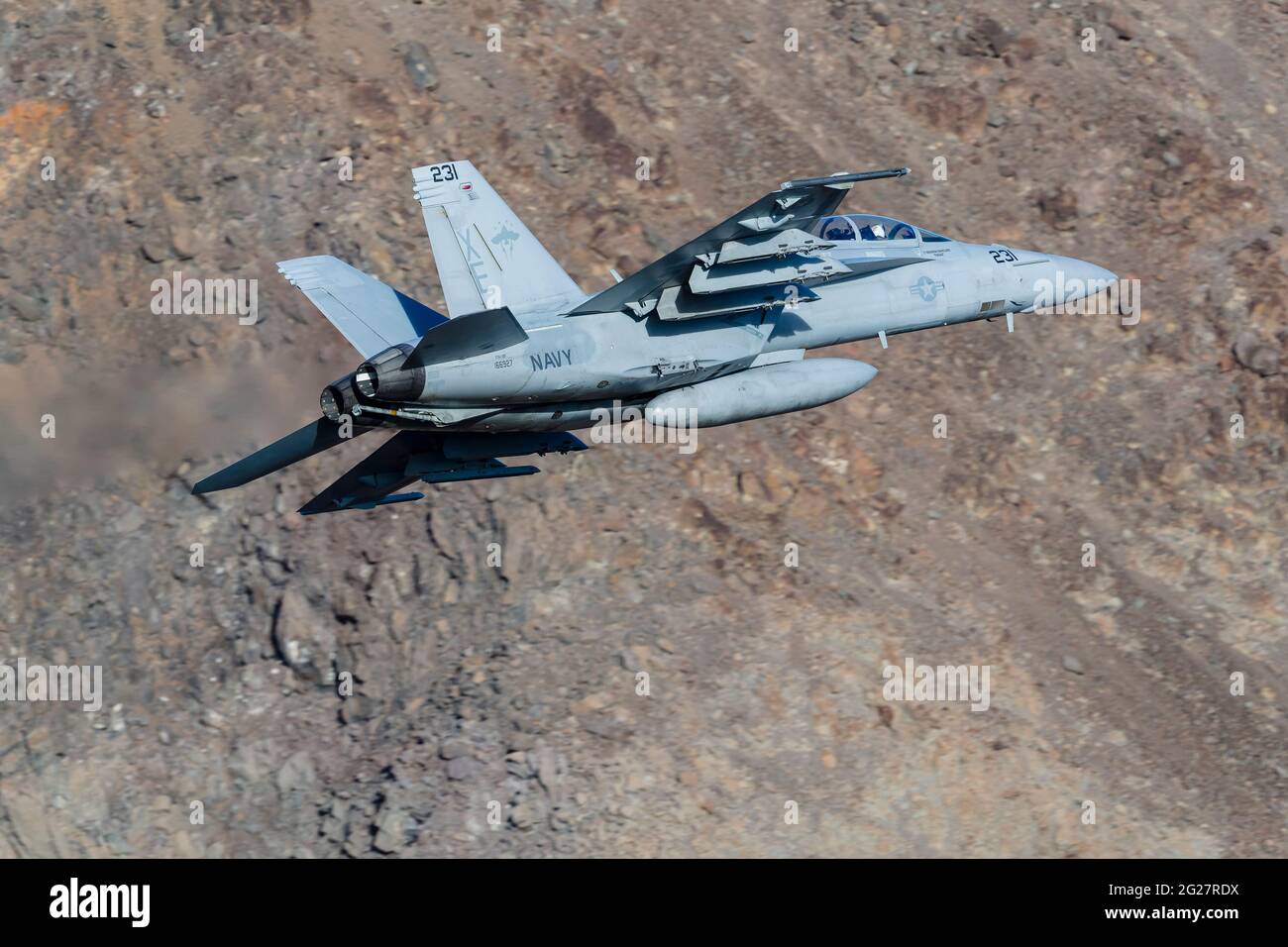 A U.S. Navy F/A-18F Super Hornet flies through Death Valley, California. Stock Photo