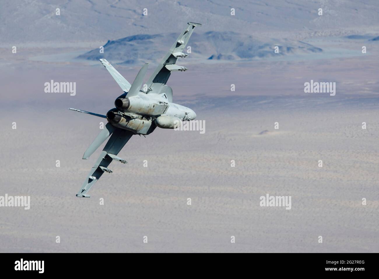 A U.S. Navy F/A-18E Super Hornet flies through Death Valley, California. Stock Photo