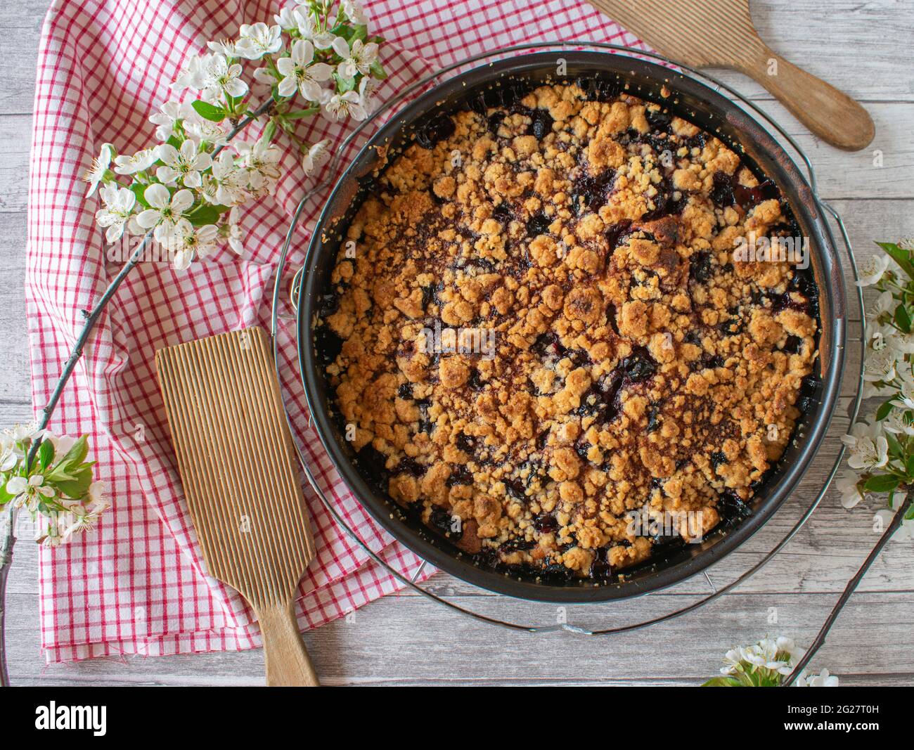 Traditional fresh baked cherry crumble cake in a springform or baking