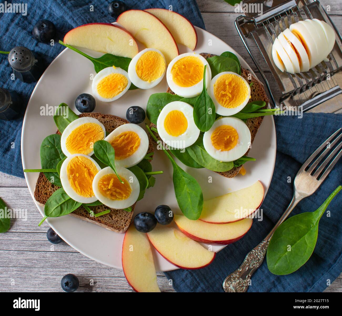 A plate with healthy sandwiches and fruits on a table. Table top view Stock Photo
