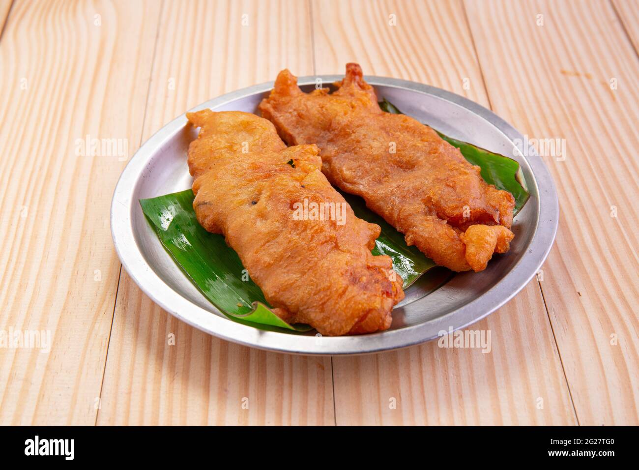 Banana Fritters Or Banana Fry Or Pazham Pori Indian Fried Snack Isolated On Steel Plate Lined With Banana Leaf On Wooden Background Stock Photo Alamy