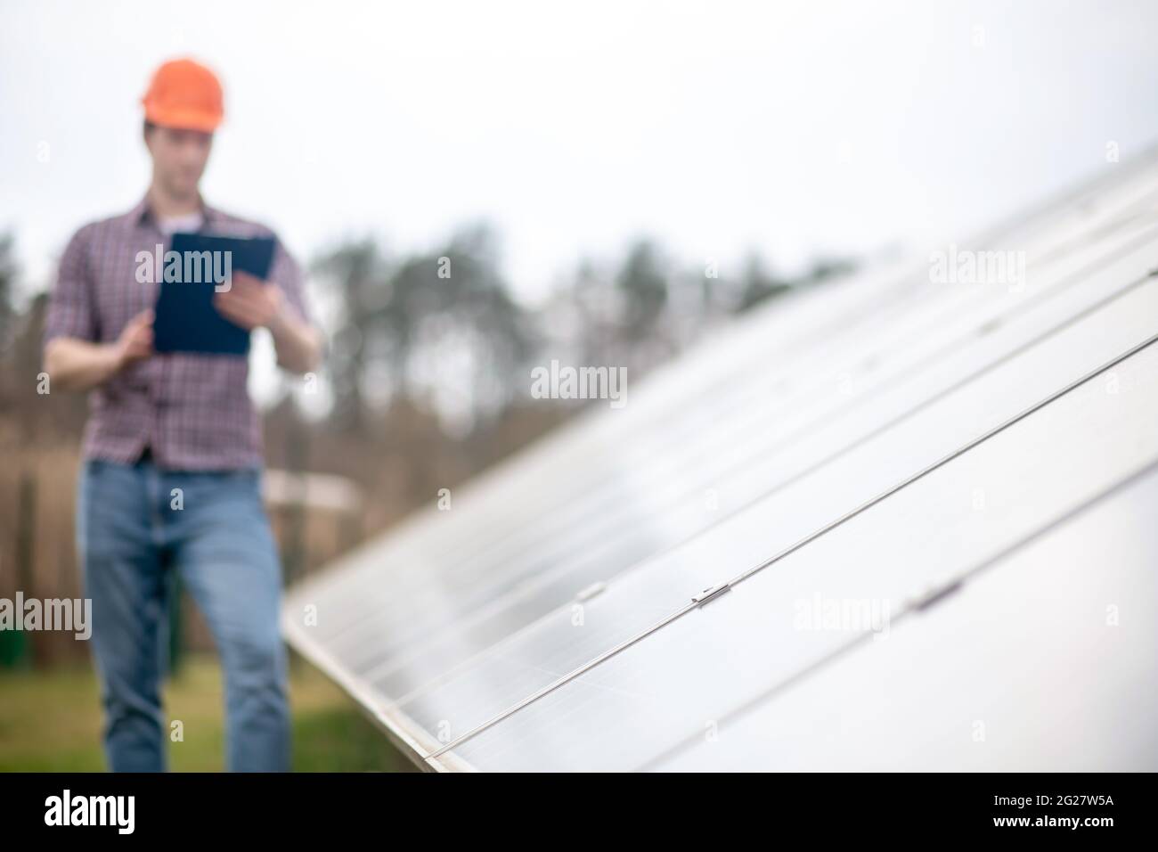 Special design surface and man in helmet with folder Stock Photo