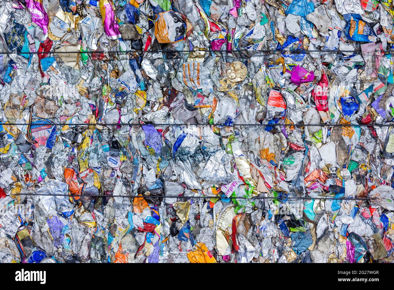 Erftstadt, Germany. 08th June, 2021. Sorted packaging waste stands pressed next to a hall after it has been separated in the sorting plant of the waste disposal company Remondis. Credit: Rolf Vennenbernd/dpa/Alamy Live News Stock Photo