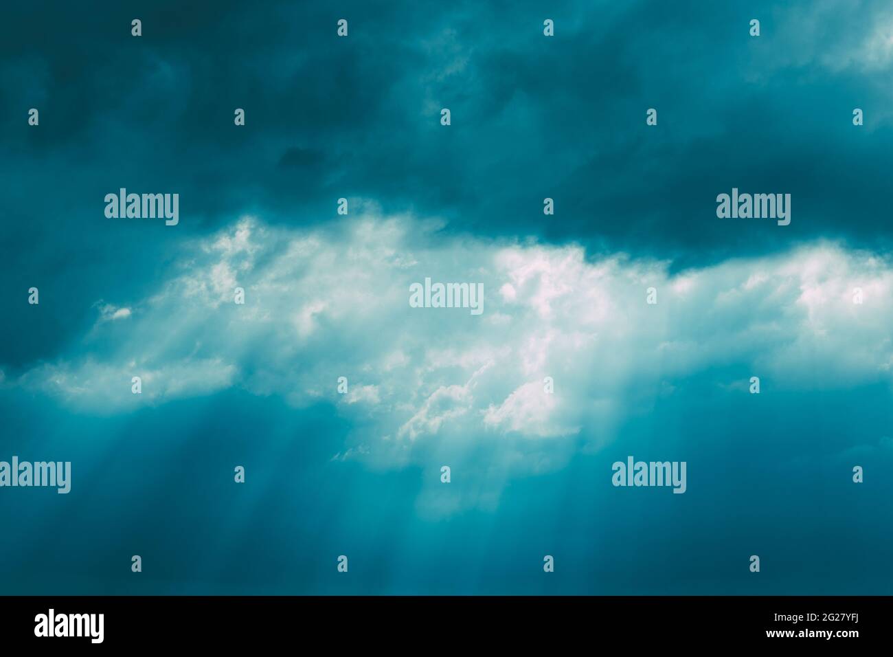 Sunrays Through Blue Rainy Dramatic Sky. Natural Abstract Background Stock Photo