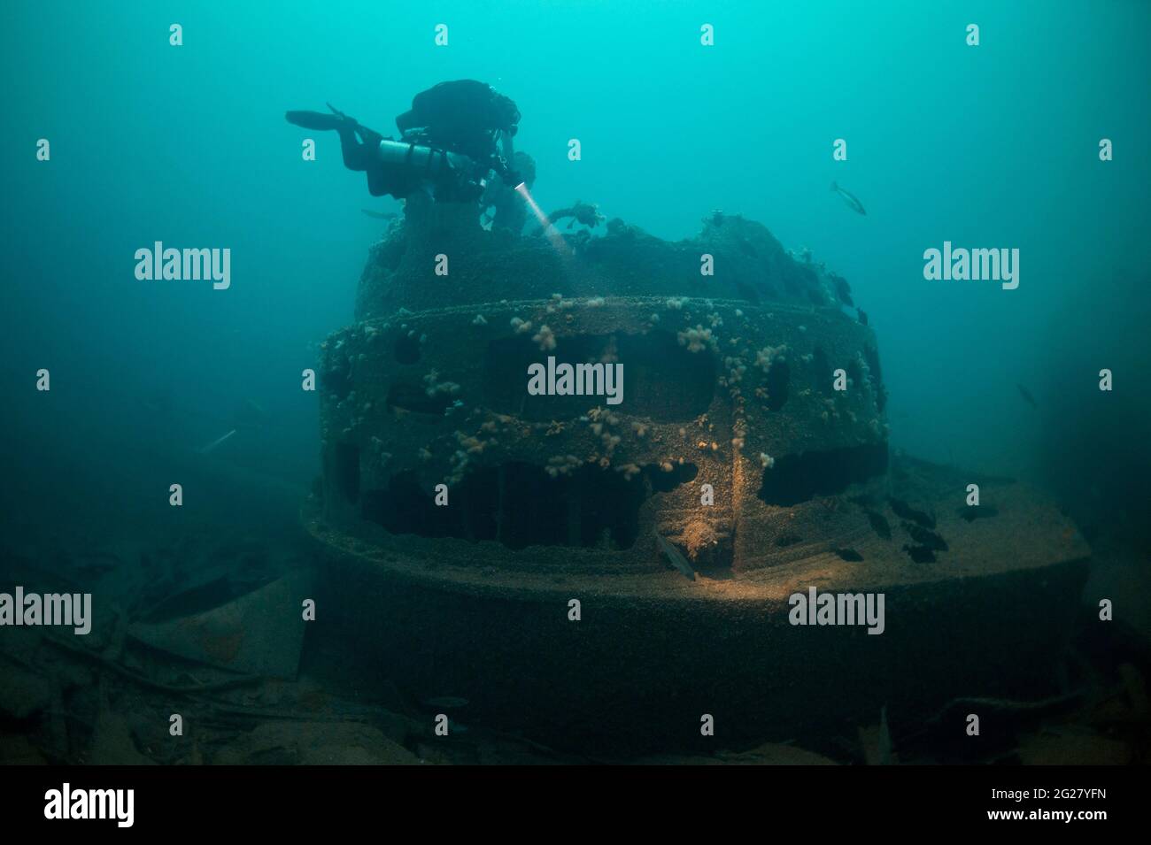 Diver exploring the forward gun turret of the British HMS Audacious battleship wreck. Stock Photo