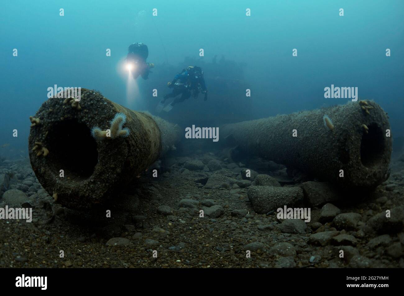Two divers exploring the HMS Audacious shipwreck. Stock Photo