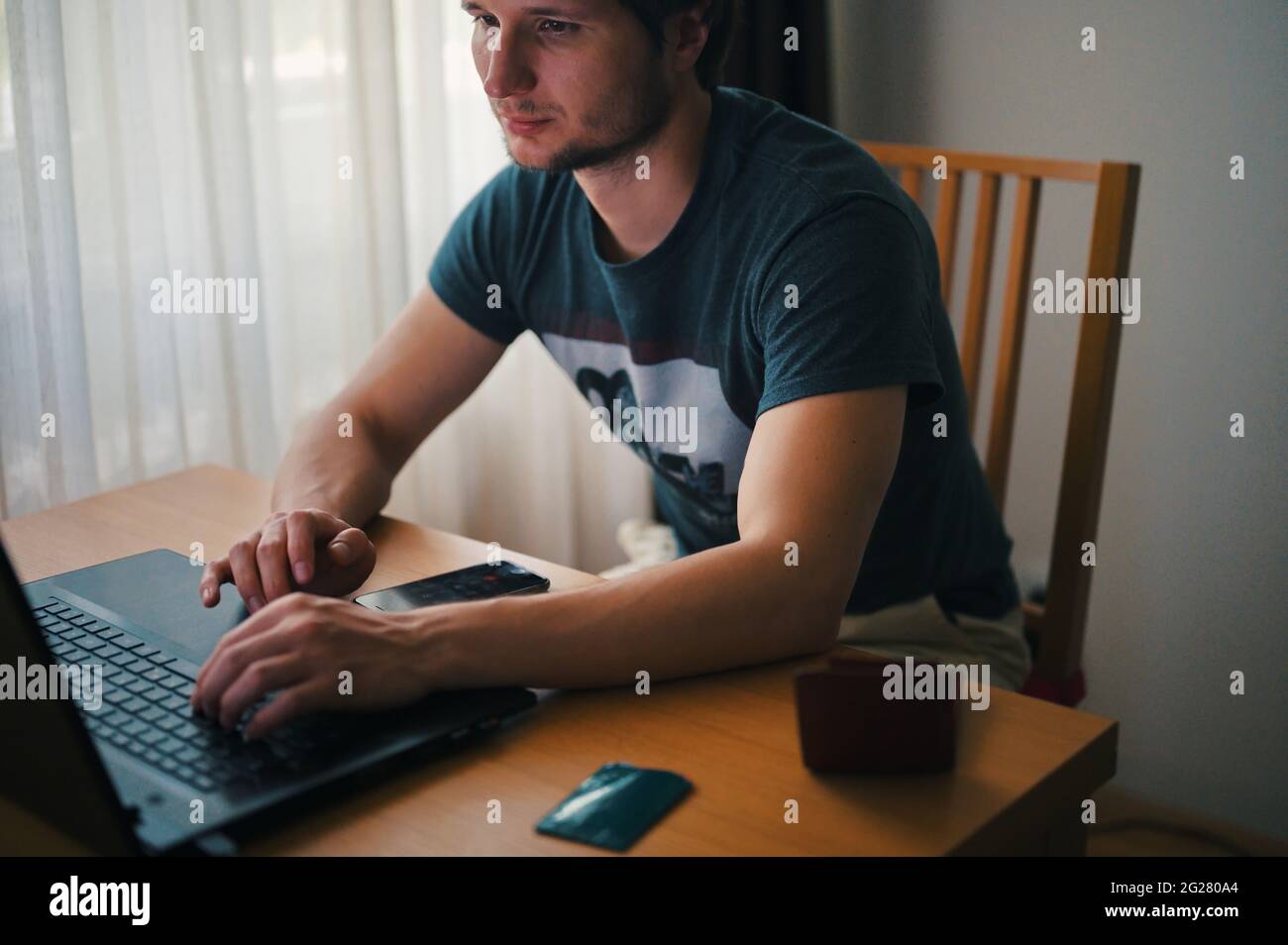 Mature man using laptop while sitting at home Stock Photo