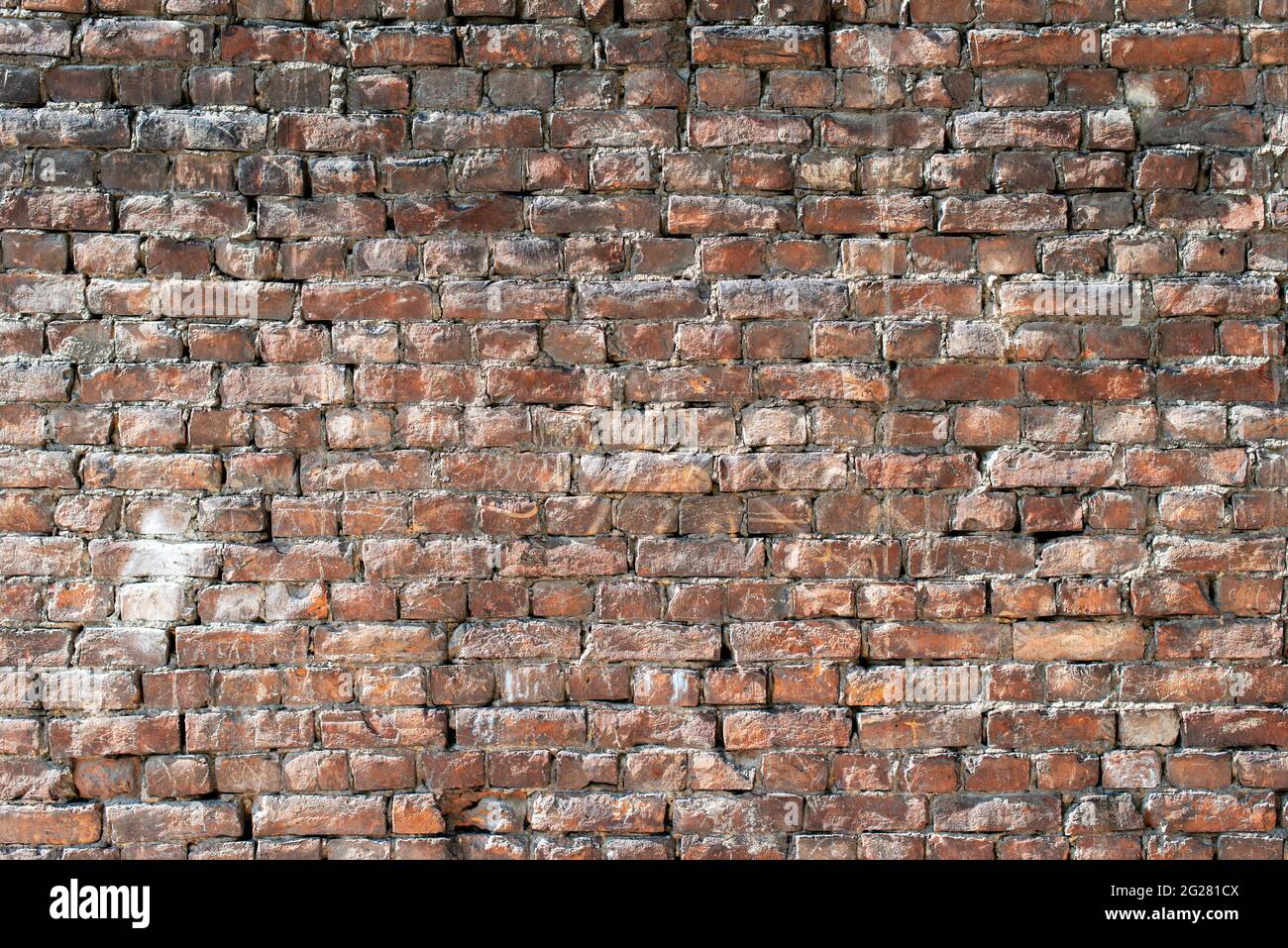 Old brick wall with bulging parts as background. Stock Photo
