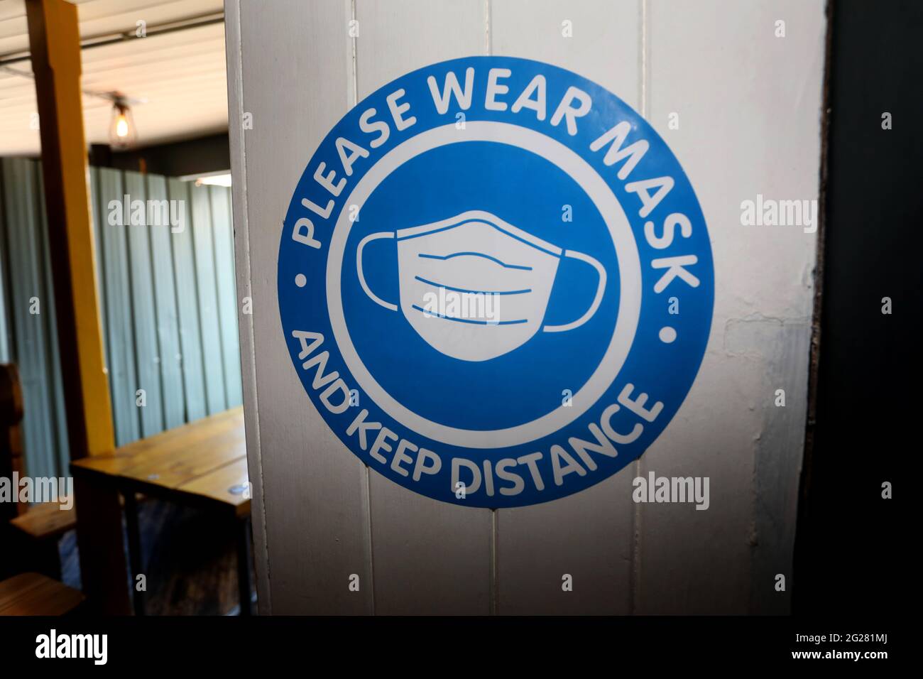 Please wear a mask sign in a pub in Portsmouth, Hampshire, UK. Stock Photo