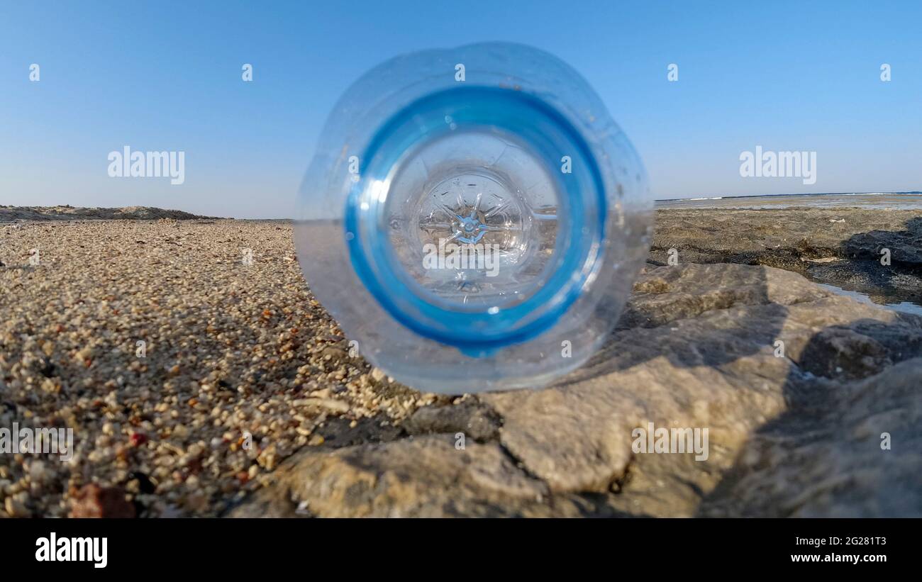 Bottle neck close-up on a sunny day on the beach. plastic problems Stock Photo