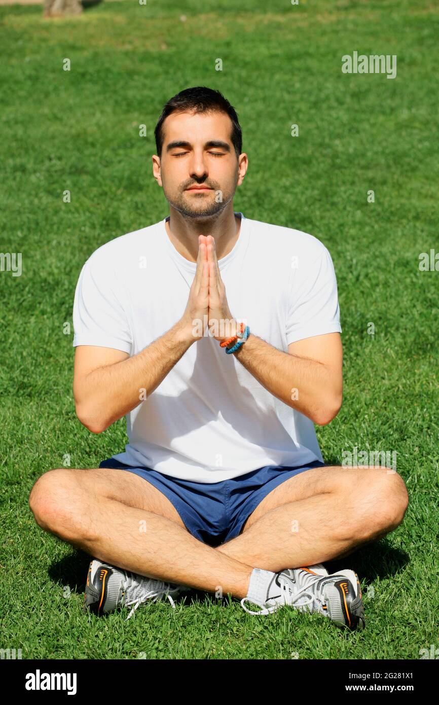 young man doing yoga in Stock Photo