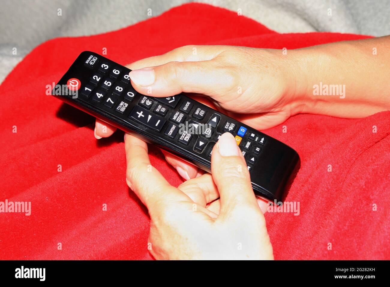 holding remote control with two hands Stock Photo