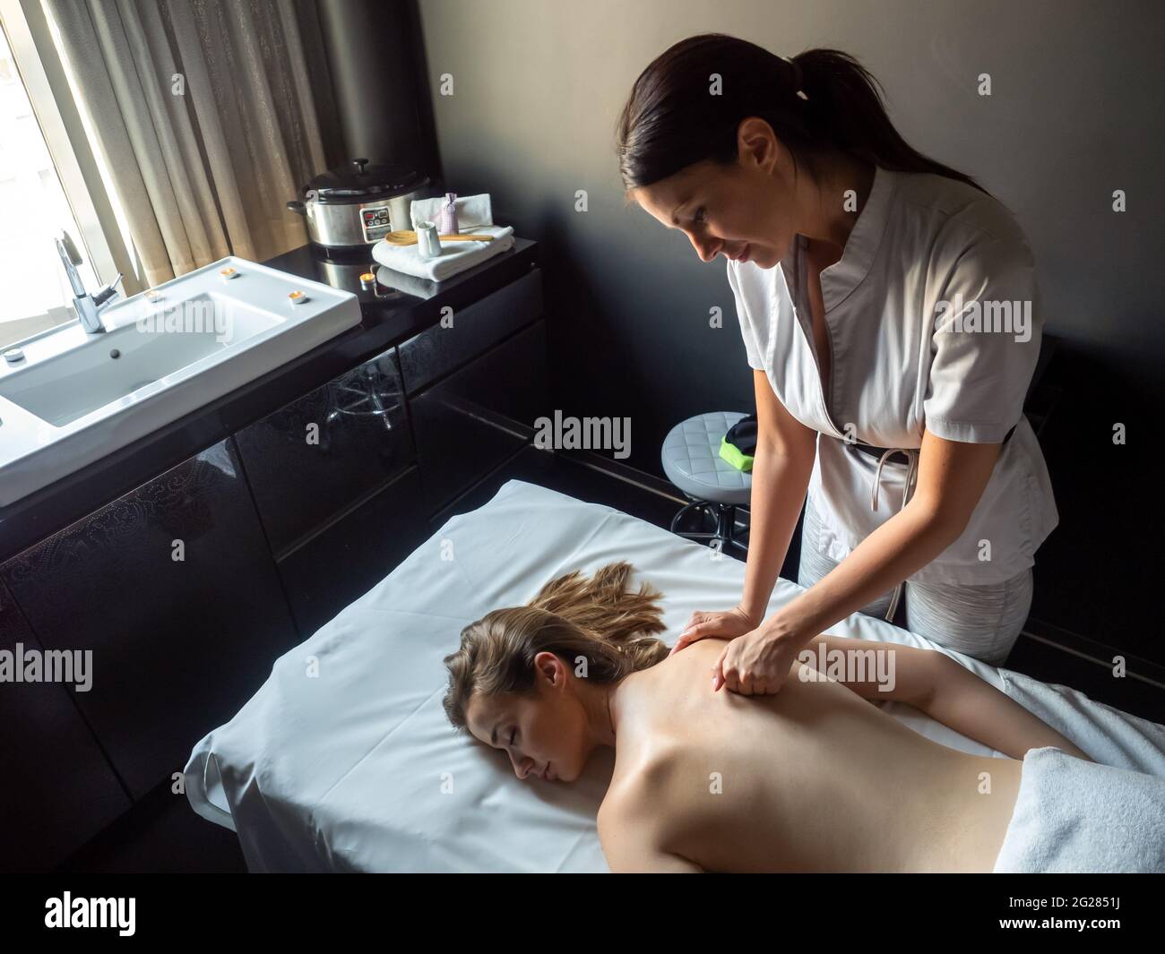 Woman having massage of body in the spa salon. Beauty treatment concept. Stock Photo