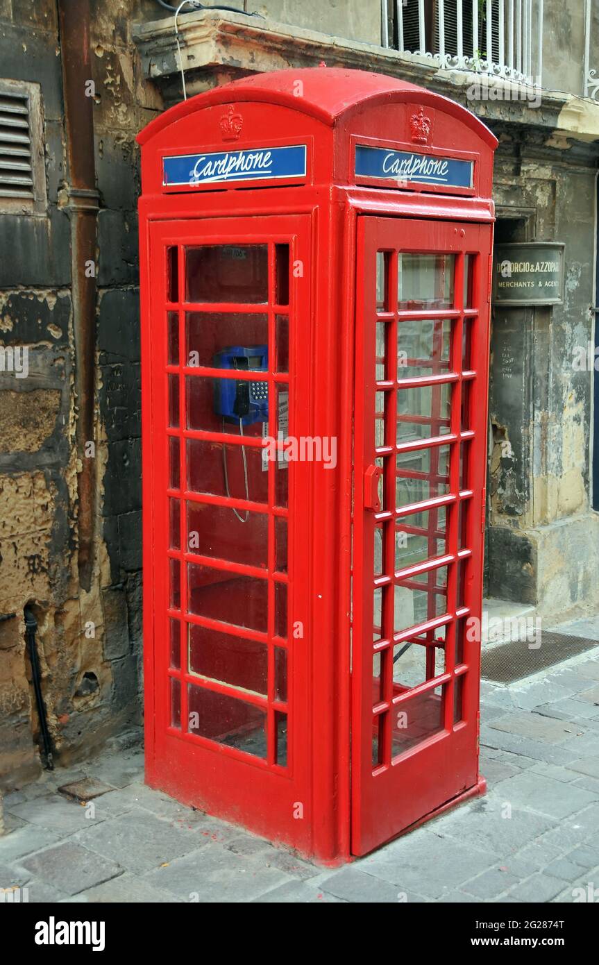 Traditional red telephone booth on street of Valletta, Malta Stock