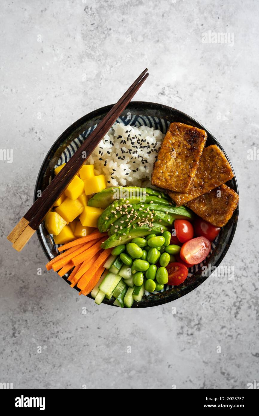 Top Down View Of A Homemade Vegan Poke Bowl With Tofu Mango Avocado Carrot Edamame Tomato