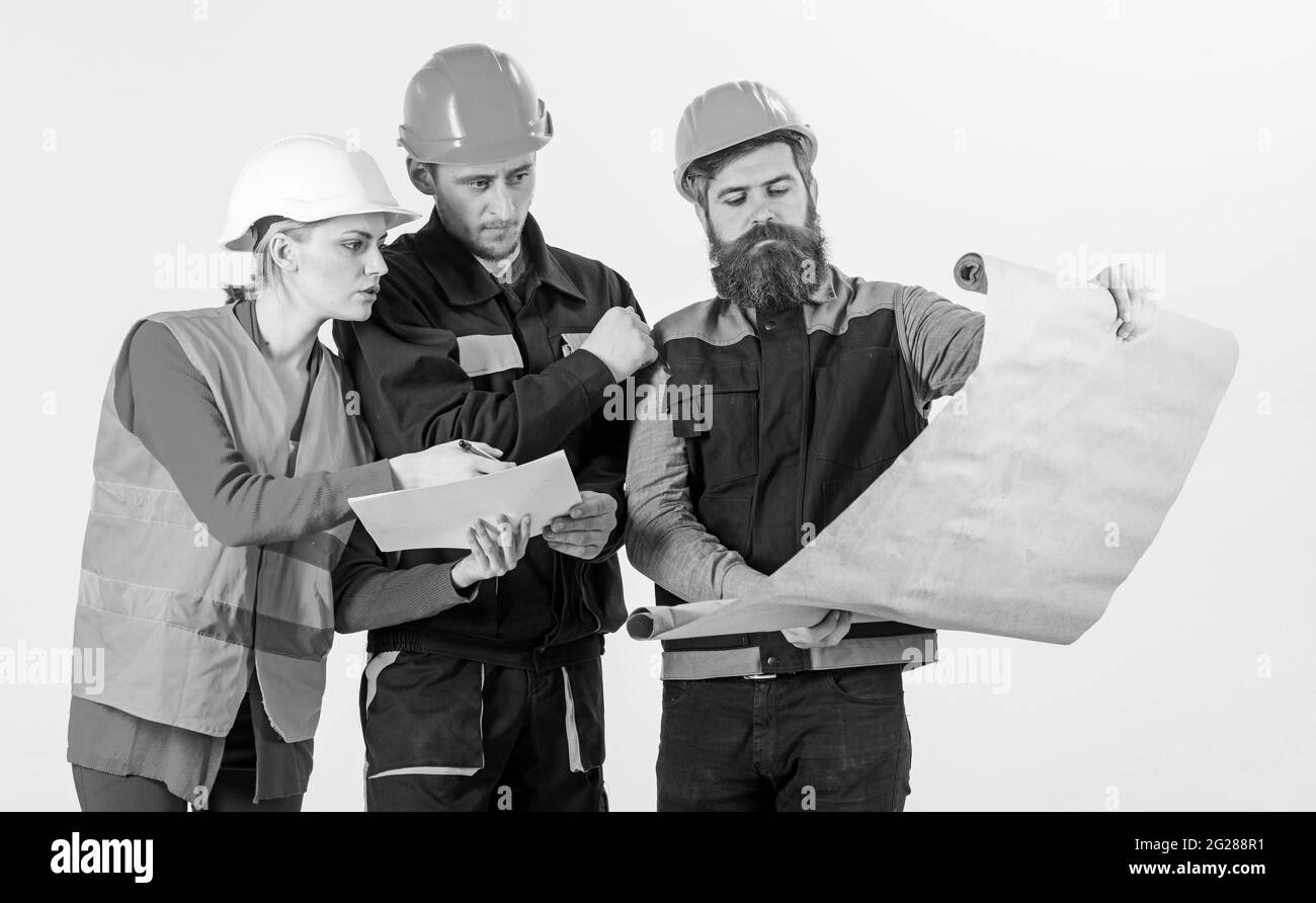 three construction engineers working together, planning for renovation ...