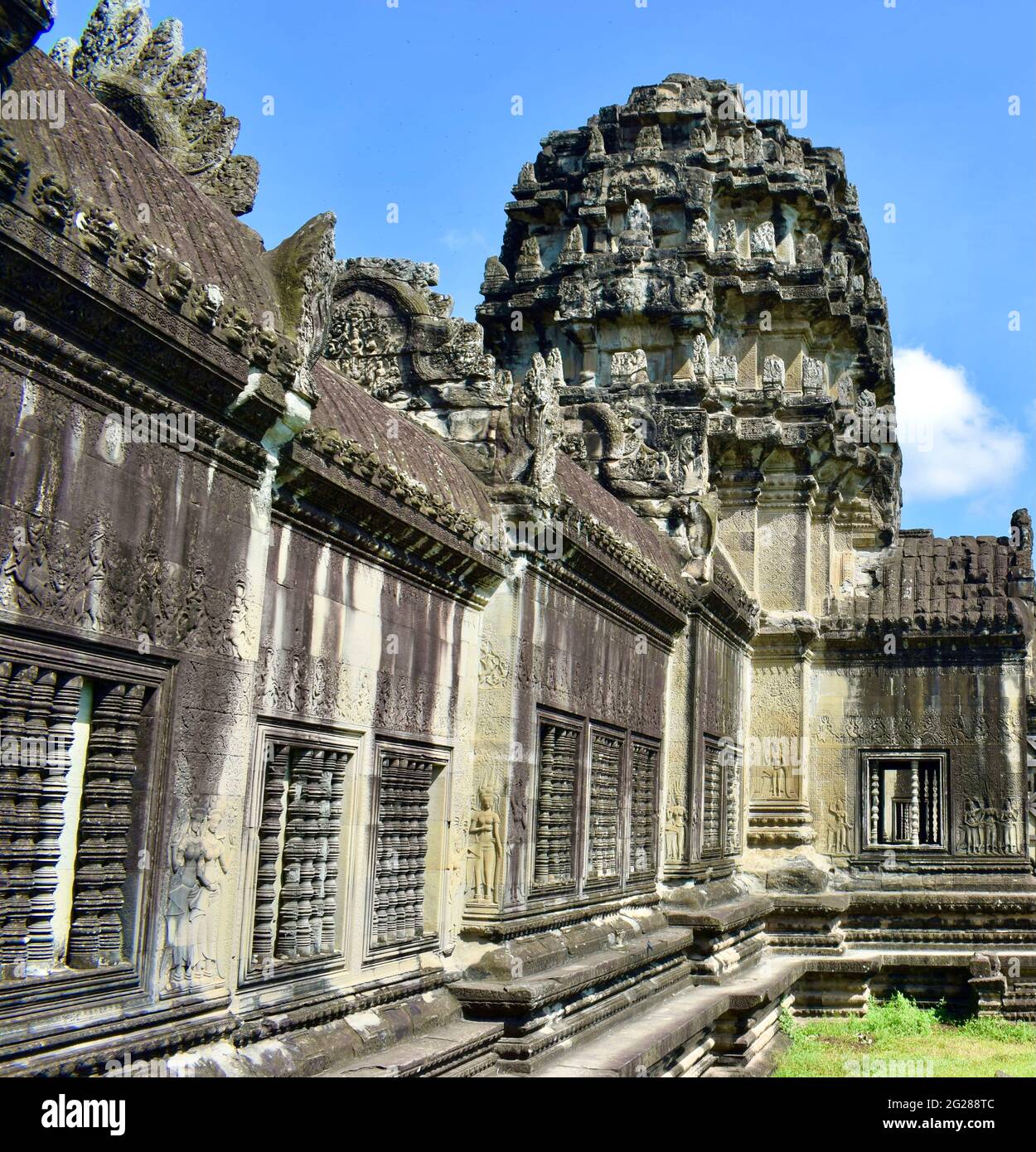 Tower structure and carvings along the outer wall of Angkor Wat in Cambodia. Stock Photo
