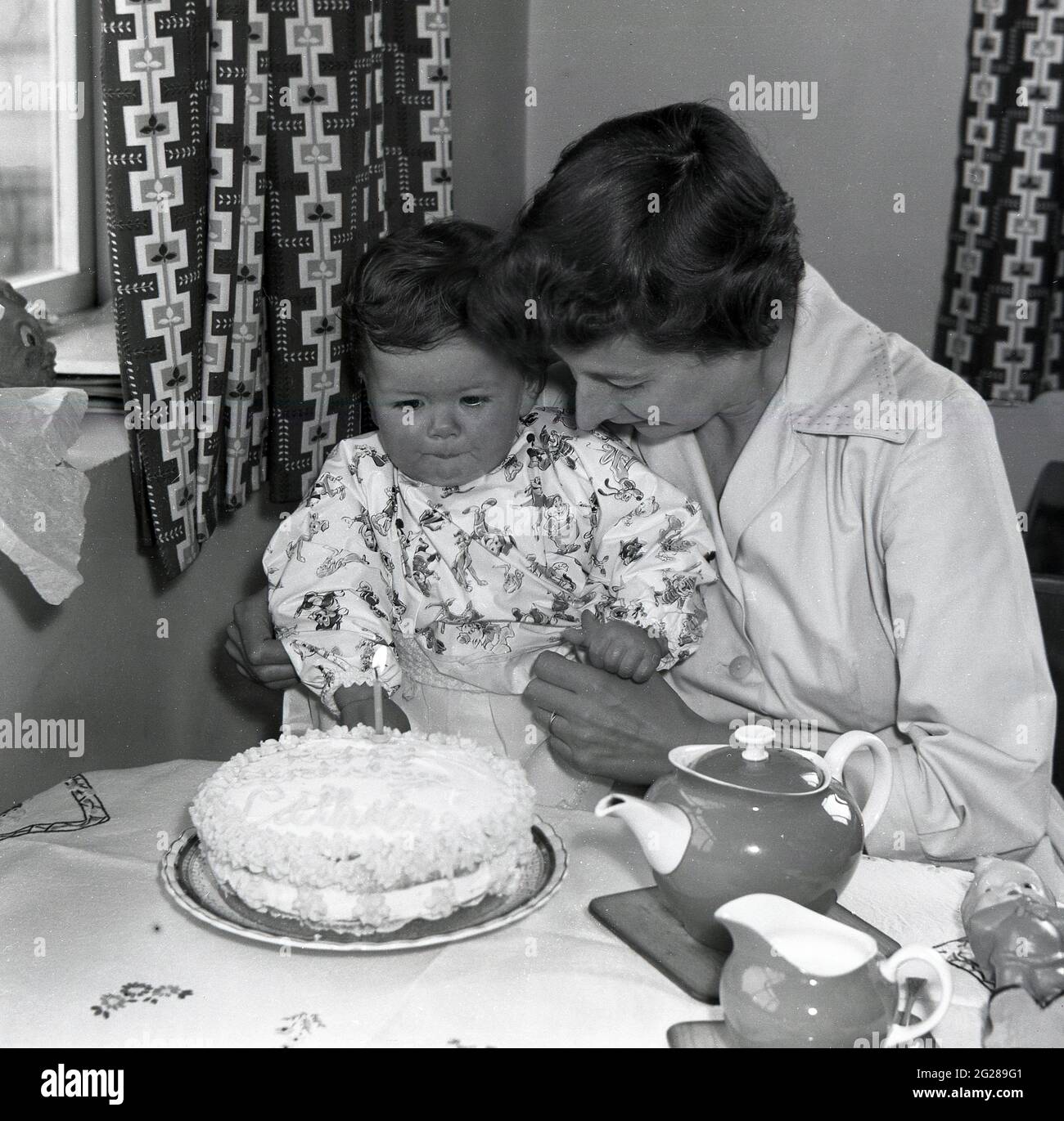 1960s, historical, birthday celebration, sitting at a table holding her