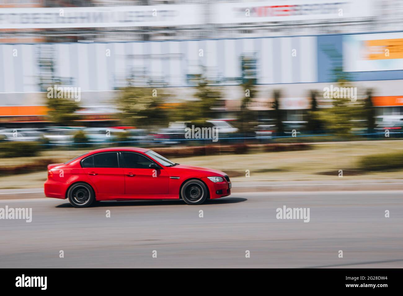 Ukraine, Kyiv - 13 May 2021: Red BMW 3 series car moving on the street. Editorial Stock Photo