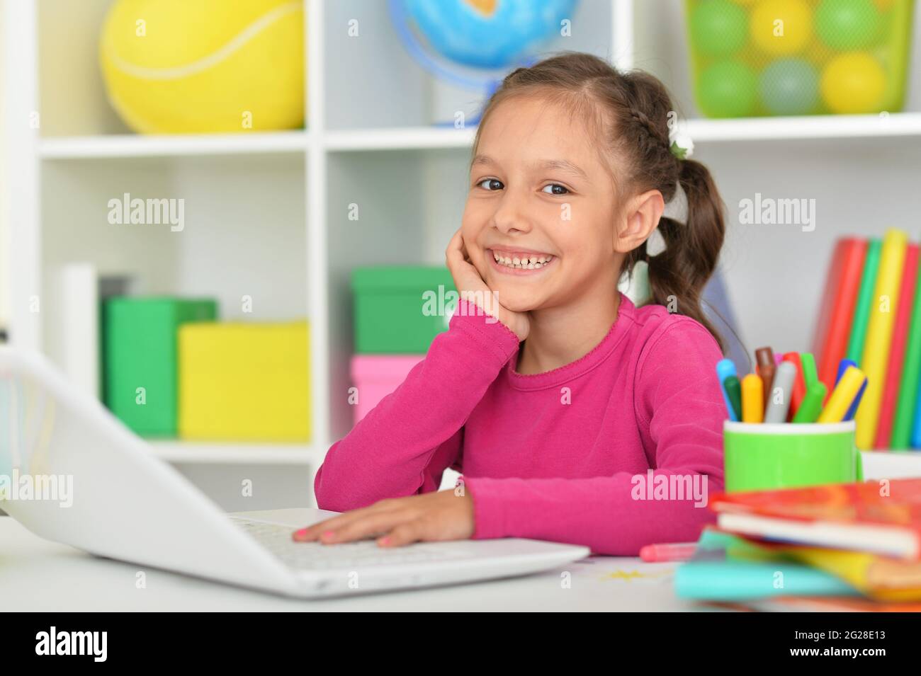 Porait of cute girl using laptop at home Stock Photo - Alamy