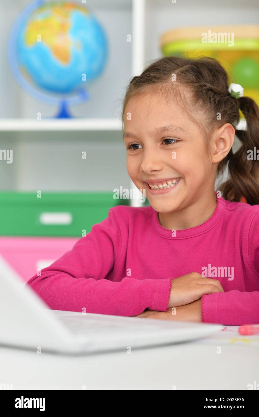 Porait of cute girl using laptop at home Stock Photo - Alamy