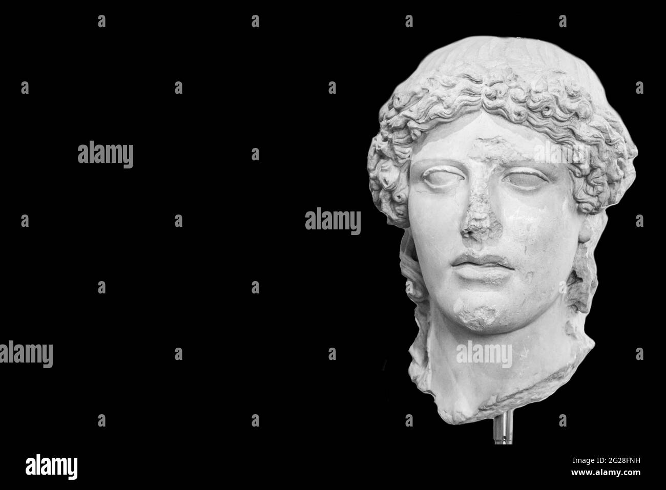 Black and white photo of head of ancient roman statue with long curly hair Stock Photo