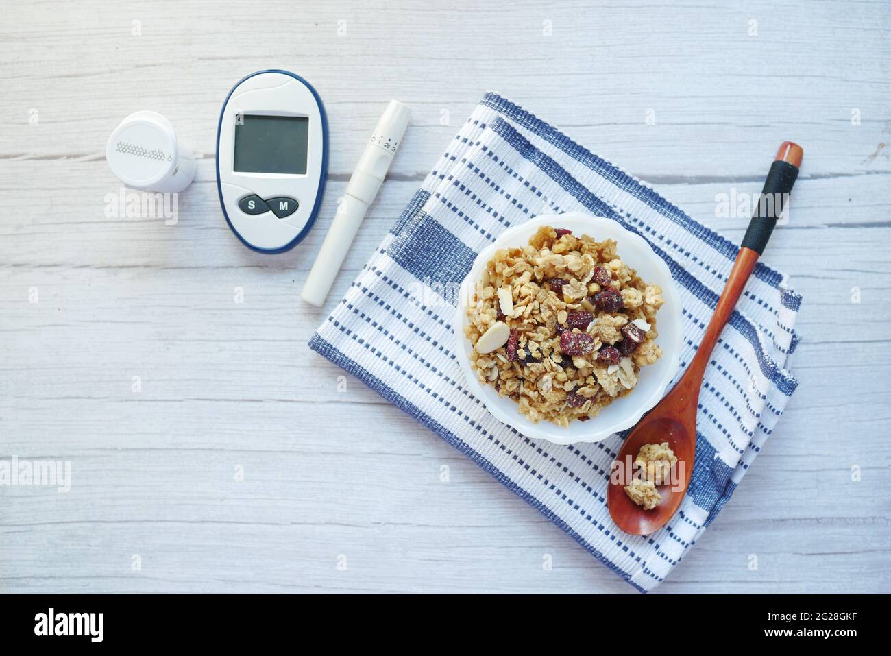 diabetic measurement tools and breakfast cereal in a bowl on table  Stock Photo