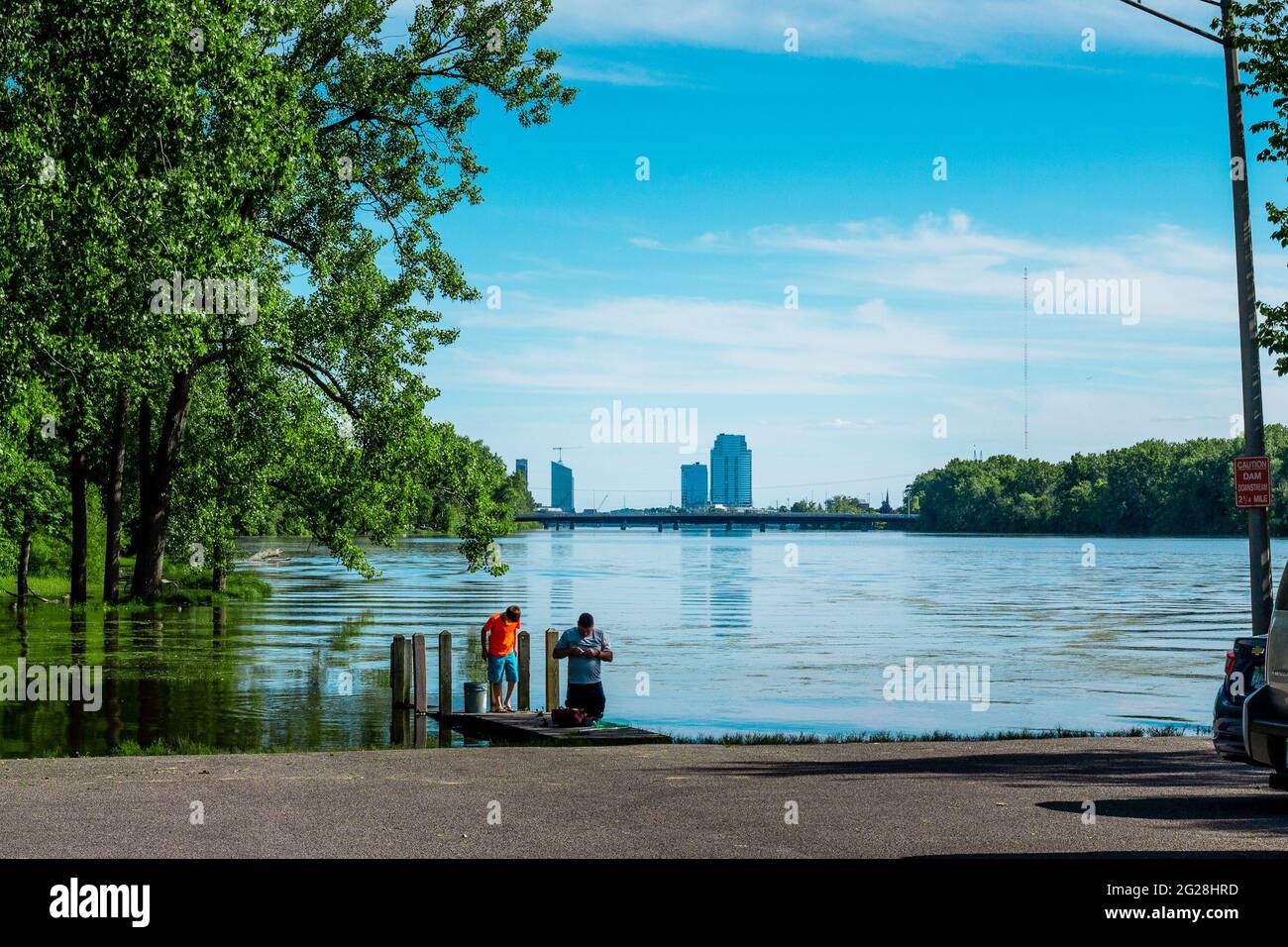 Fishing on the Grand River under the Grand Rapids skyline in the summer Stock Photo