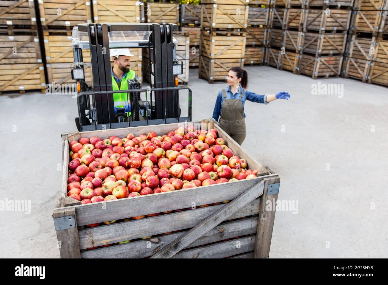Fruit warehouse management, business and production of juice and puree smiling confident Stock Photo