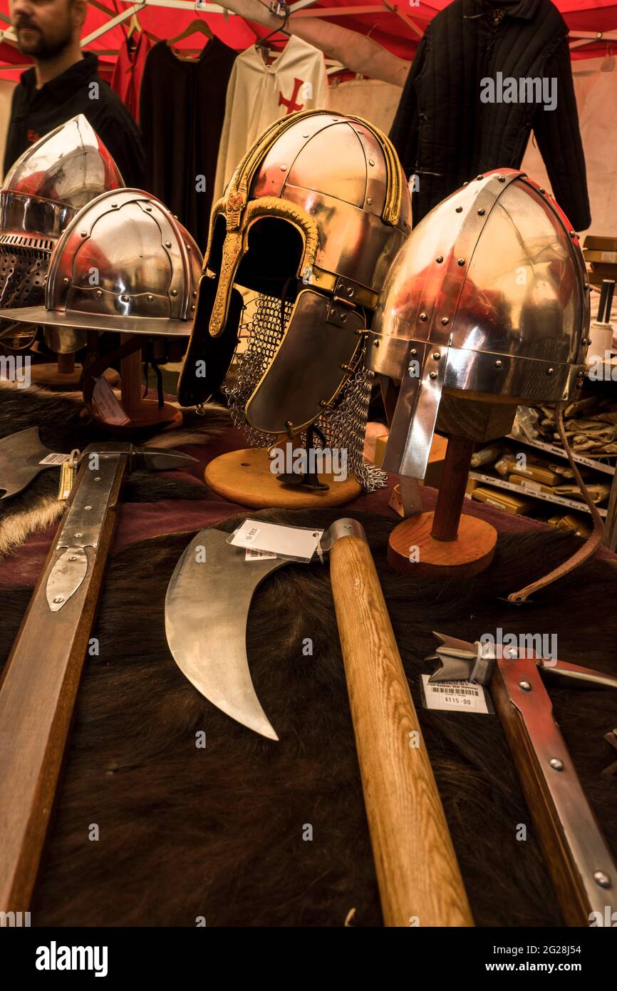 Display of replica medieval helmets, weapons and clothing for sale at the Abbey Medieval