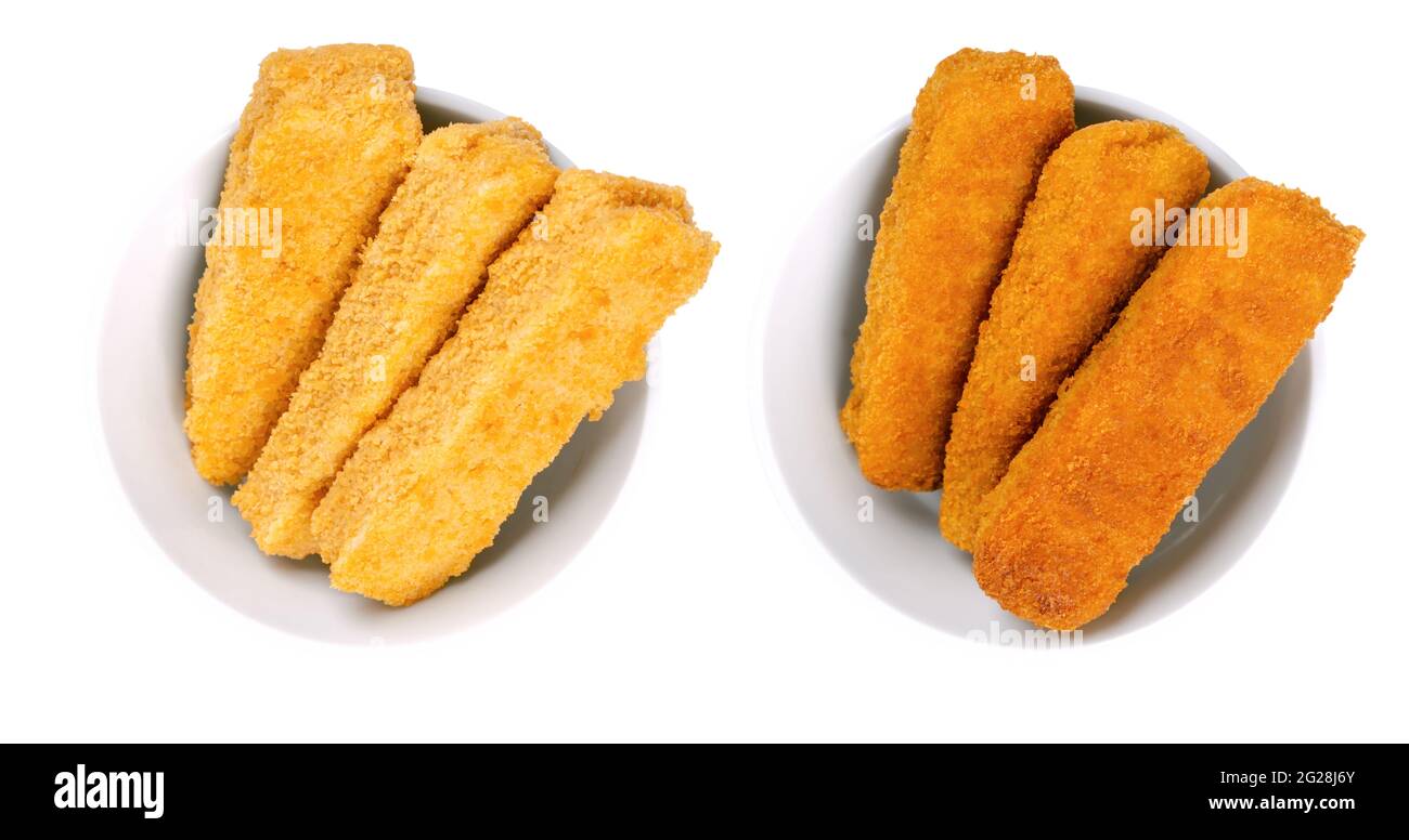 Vegan fishless fingers, pre-fried and deep-fried, in white bowls. Fishless sticks, based on soy protein, breaded and crispy coated. Fast food. Stock Photo