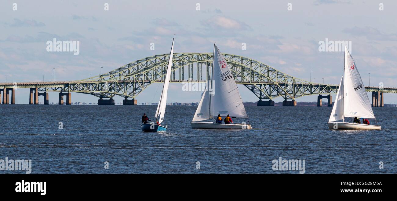 Babylon, New York, USA – 7 December 2019: Small sailboats in a winter regatta sailing with the Great South Bay Bridge in the background Stock Photo