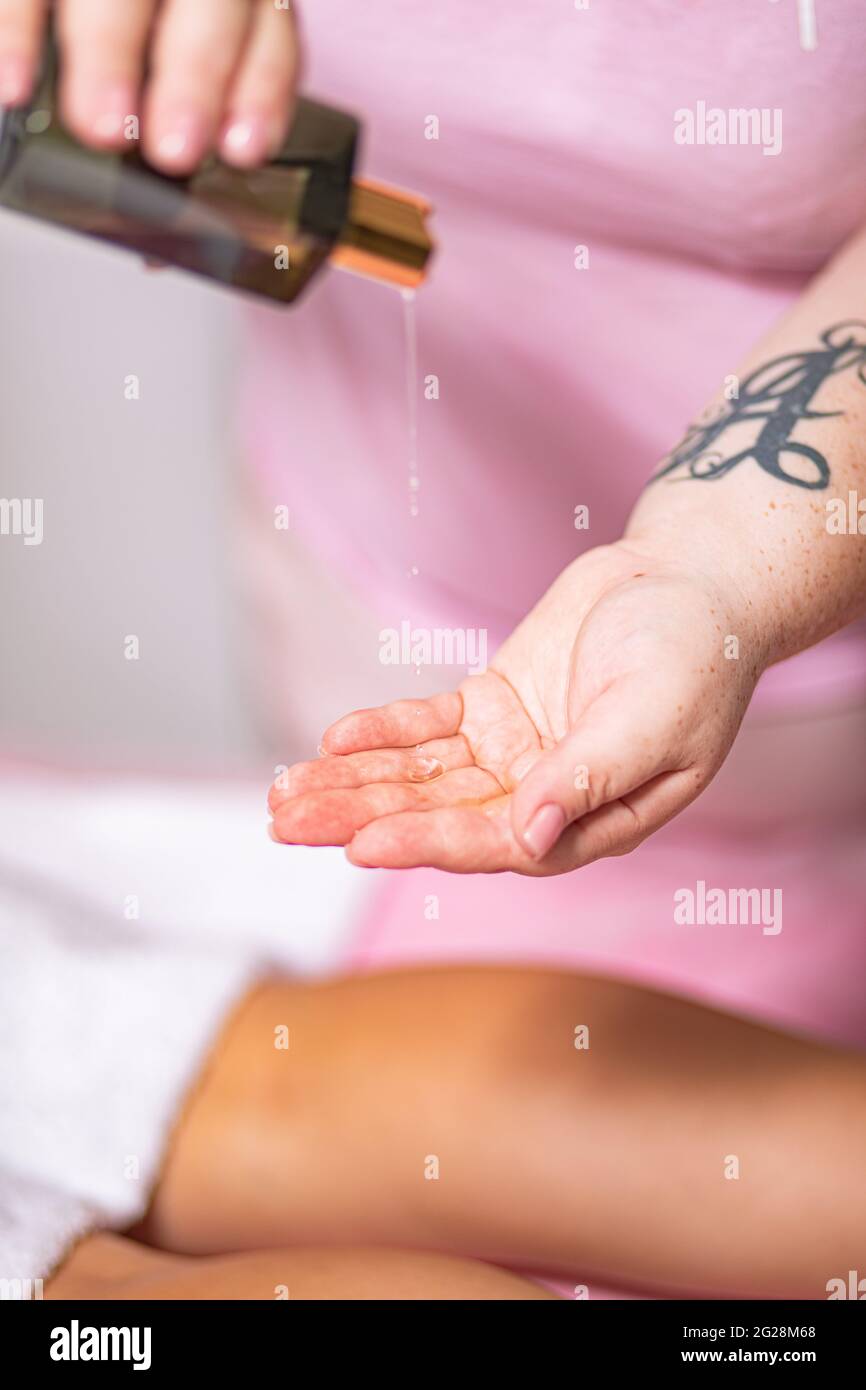 waxing procedure in a massage parlor wax on the body Stock Photo