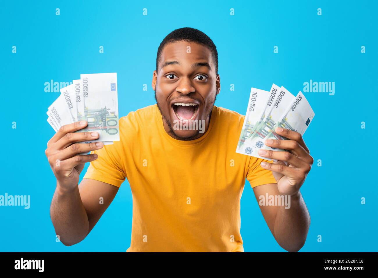 Black Guy Showing Euro Money Shouting In Joy, Blue Background Stock ...