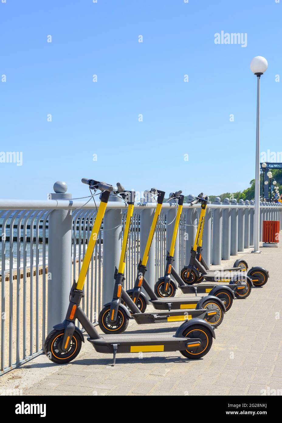 Electric scooters parked on the waterfront for rent. Stock Photo