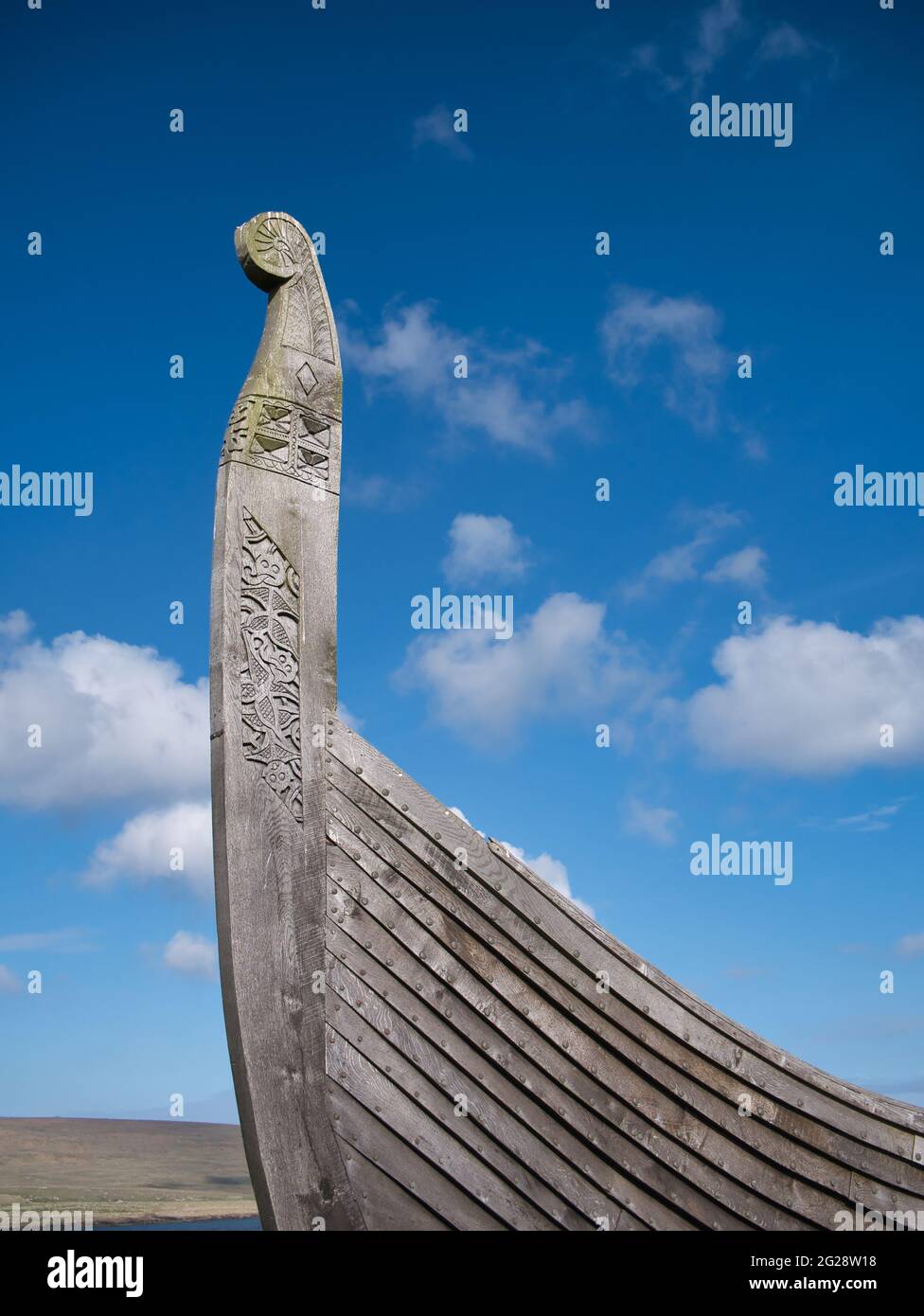 On a sunny day with light cloud, the prow of the Skidbladner - a full size replica of a Viking ship near Haroldswick on the island of Unst in Shetland Stock Photo