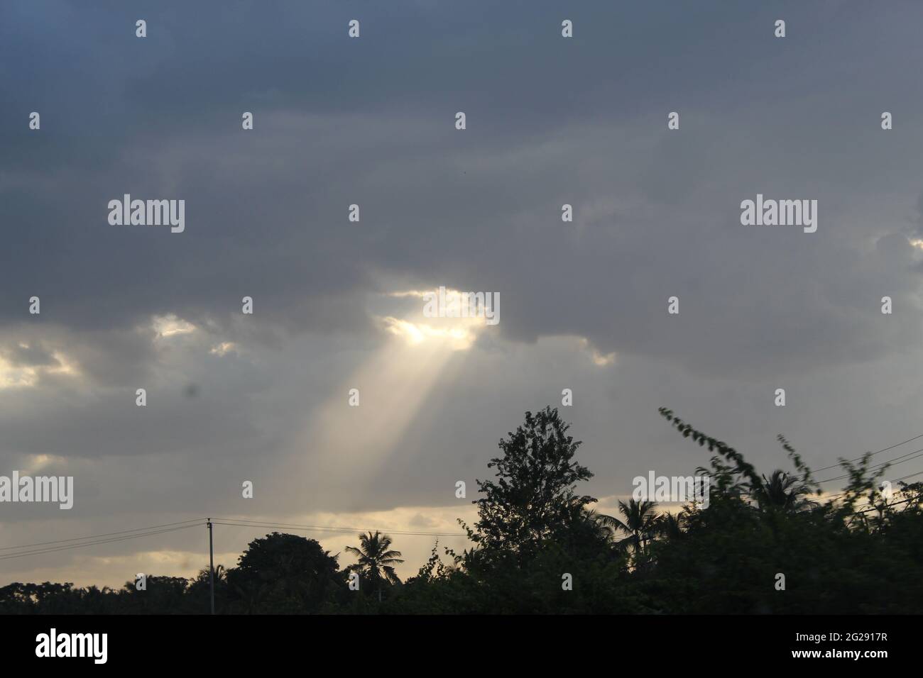 Sun Shining from between Clouds. Light from Heaven Shining. Divine and Godly Light from Sky. Sun Shining after Rain. Going to Heaven Stock Photo