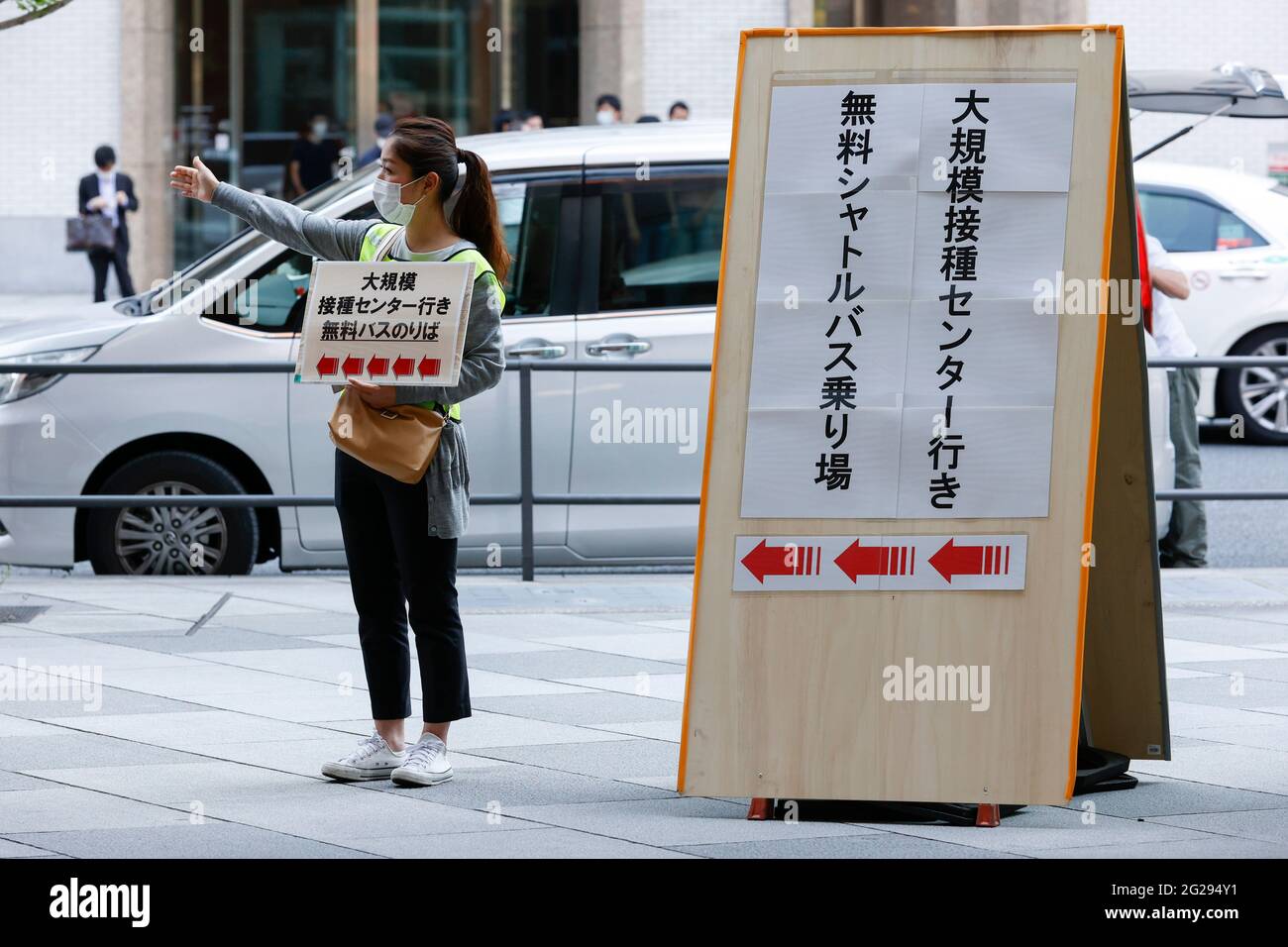 Tokyo Japan 9th June 2021 A Staff Member Indicates The Free Shuttle Bus Stop For Older Adults To Go To The Coronavirus Vaccination Center From Tokyo Station Over 170 000 People Have Received