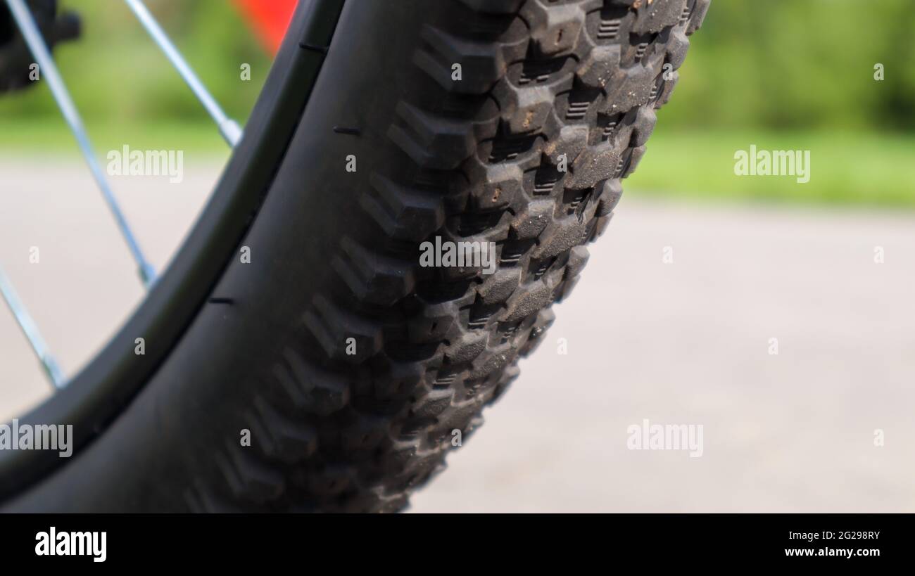 Mountain bike wheel and mud tire close Stock Photo